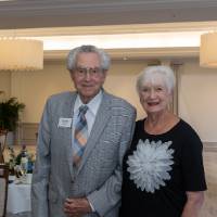 George Nosky and woman standing and smiling for camera
